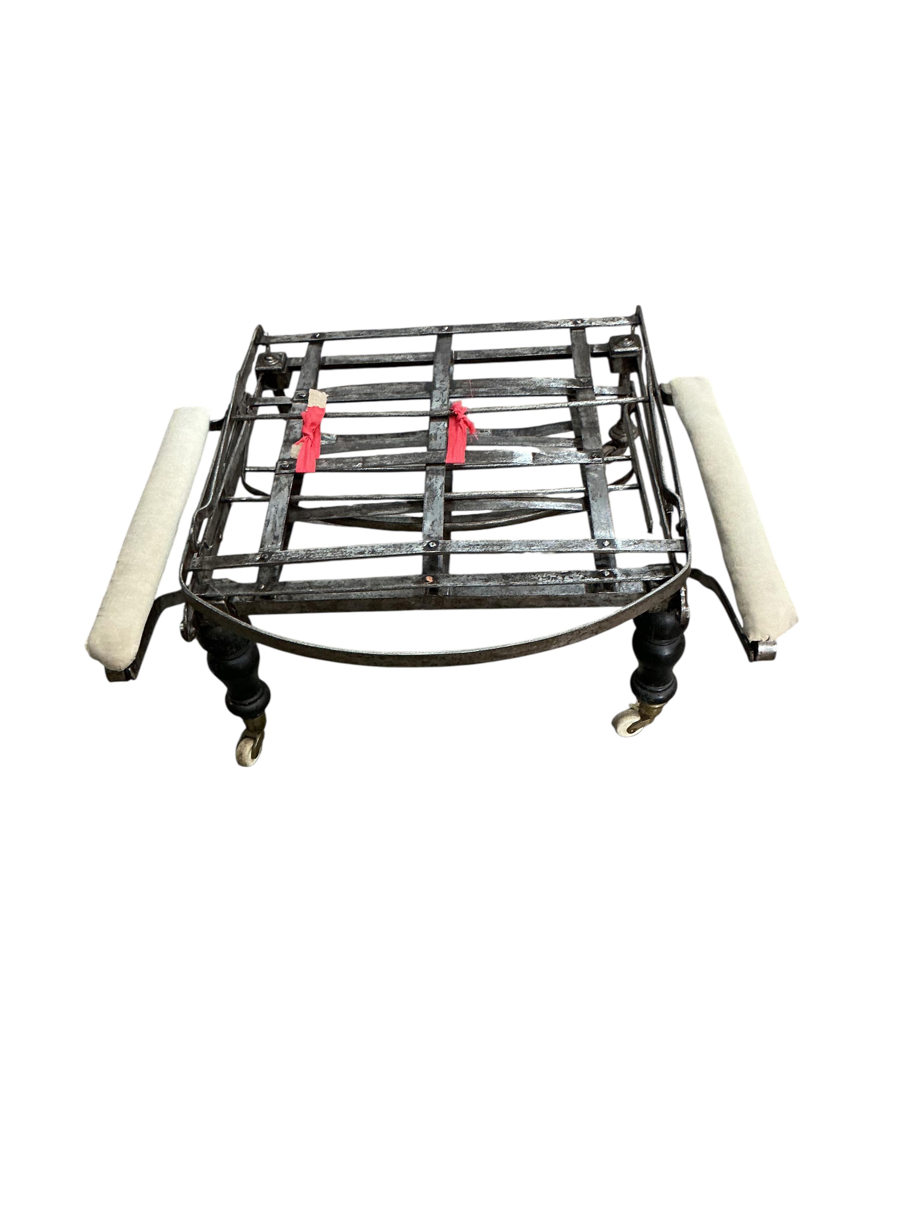 A 19th century wrought iron folding campaign day bed